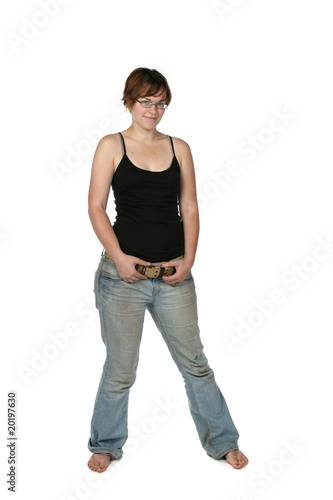 bare foot young woman in faded jeans and black tank top