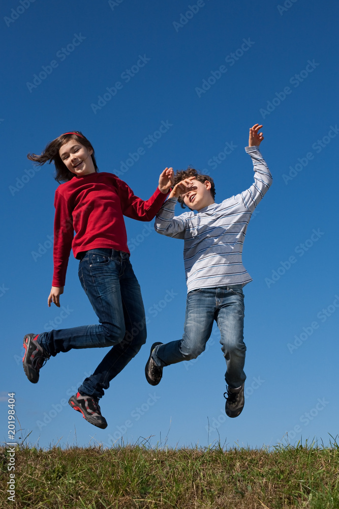 Kids jumping, running against blue sky Kids jumping, running against blue sky
