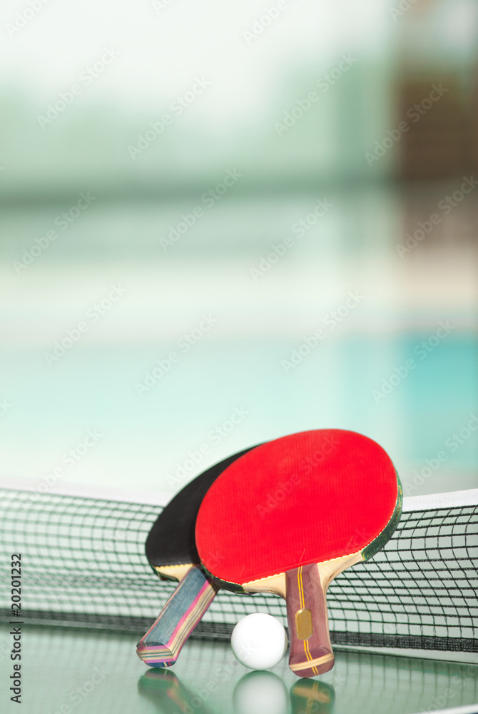 Fotografie Table tennis rackets and ball, pool in the background