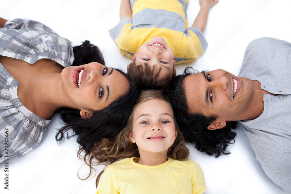 Happy family lying together on the floor in circle