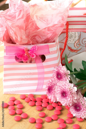 Fototapeta Naklejka Na Ścianę i Meble -  Two gift bags with pink candy around