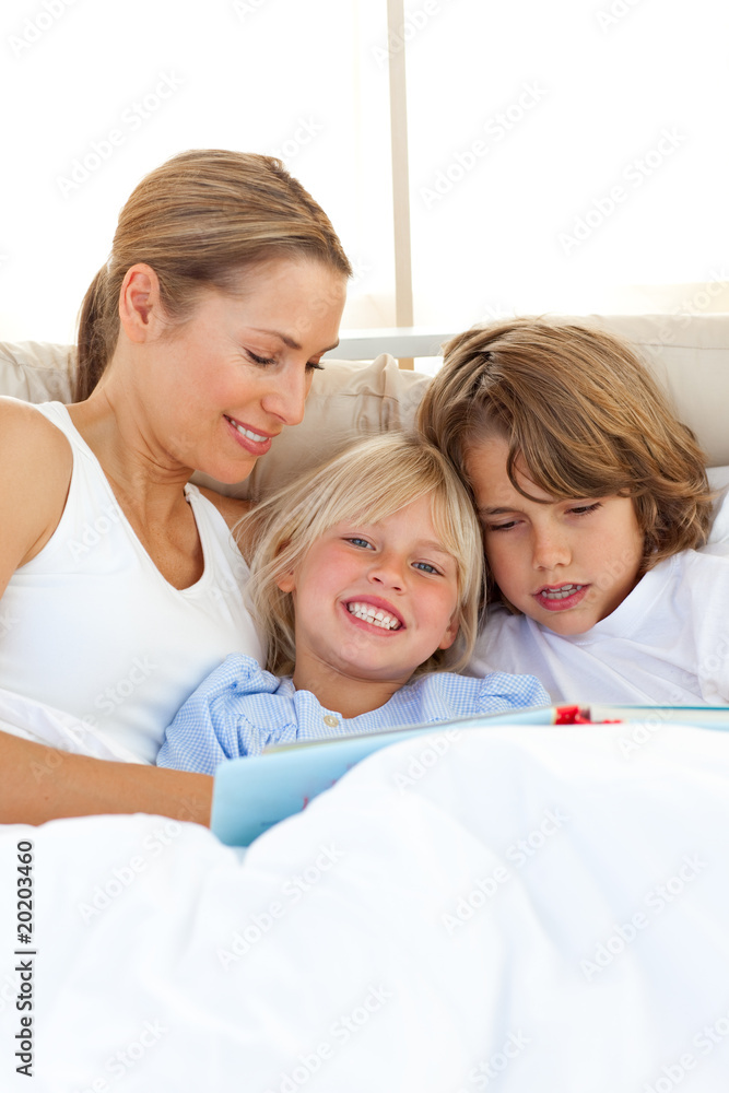 Pretty mother and her children reading book Pretty mother and her children reading book