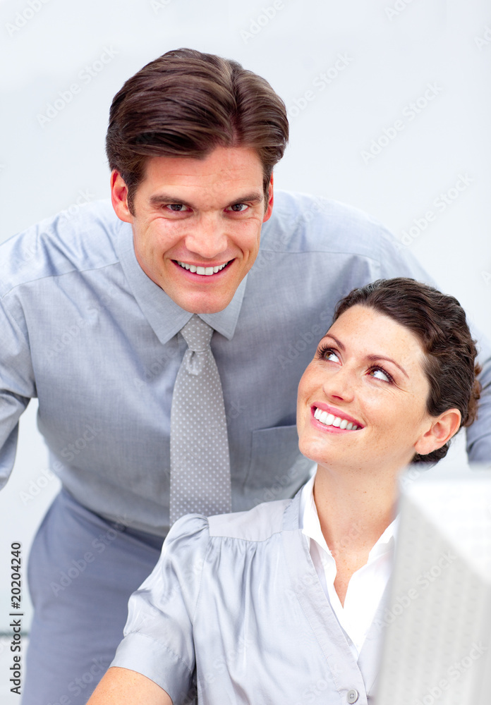 Enthusiastic business team working at a computer Enthusiastic business team working at a computer