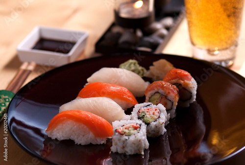 Sushi meal on a table with a beer