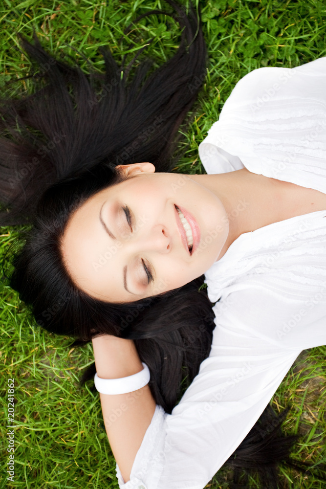 Happy woman laying on grass Happy woman laying on grass