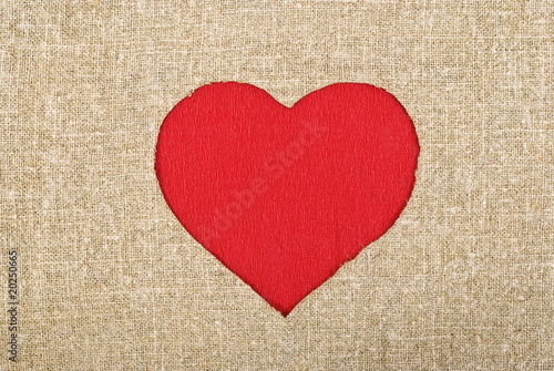 Red heart on sackcloth background