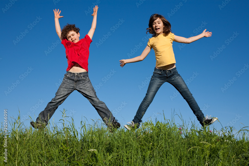 Kids jumping, running against blue sky Kids jumping, running against blue sky