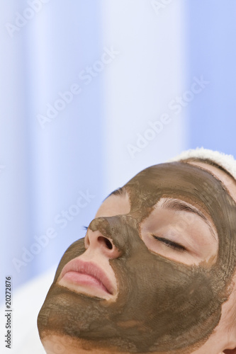 Young Woman Having Chocolate Face Mask Facial At Health Spa