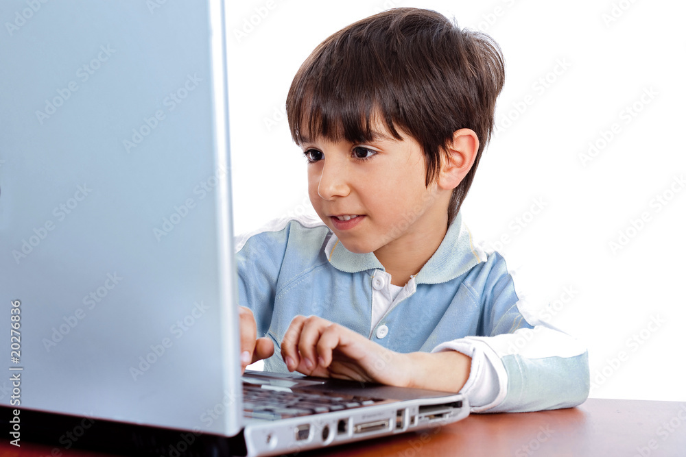 Cute caucasian kid working in laptop Cute caucasian kid working in laptop