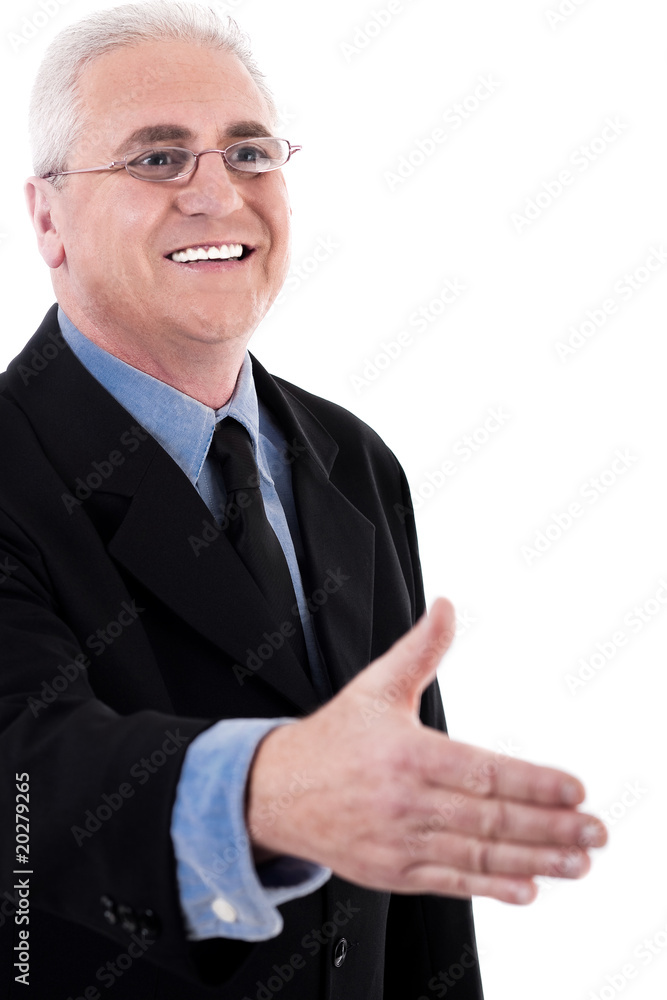 Senior business man holding out his hand for a handshake Senior business man holding out his hand for a handshake