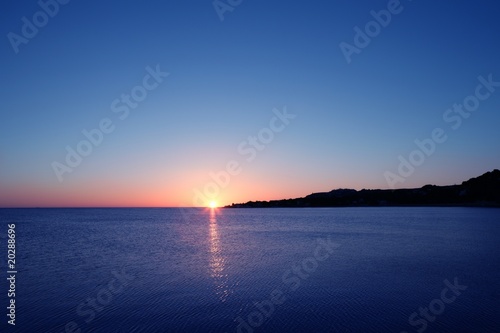 Beautiful sunset sunrise over blue sea ocean red sky