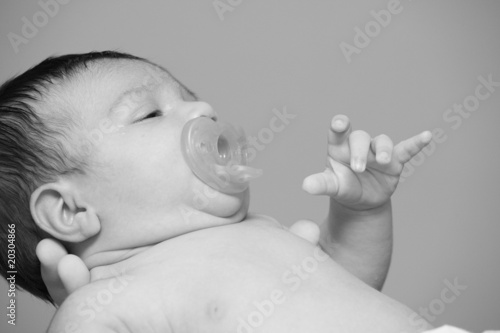 Baby being held by adutl hands photo