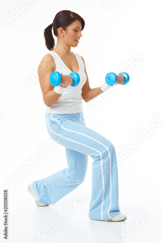 Young woman working with dumb-bells