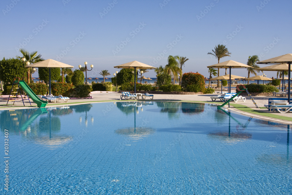 Swimming pool on a sunny day. Hurghada city in Egypt.