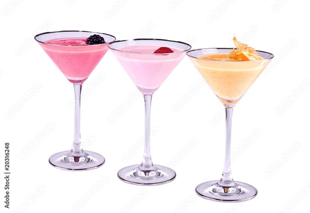 Three bright multi-coloured cocktails with the berries