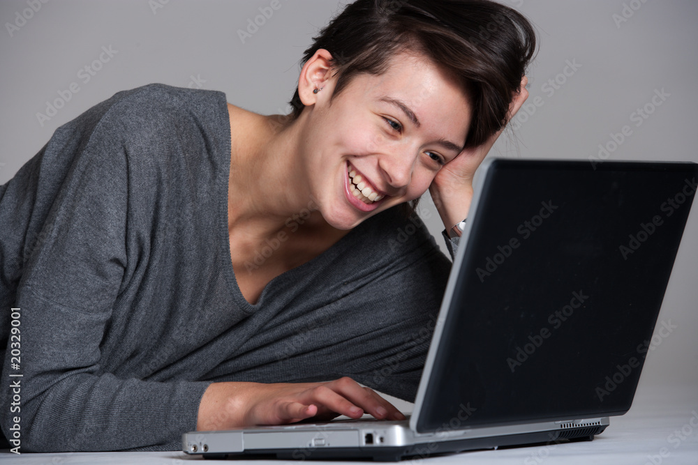 Young woman on floor with notebook Young woman on floor with notebook