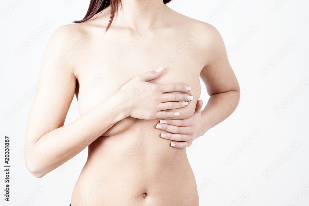 woman checking breats for signs of breast cancer woman checking breats for signs of breast cancer