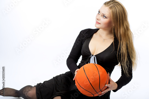 young sporty looking blond girl with backetball ball isolated
