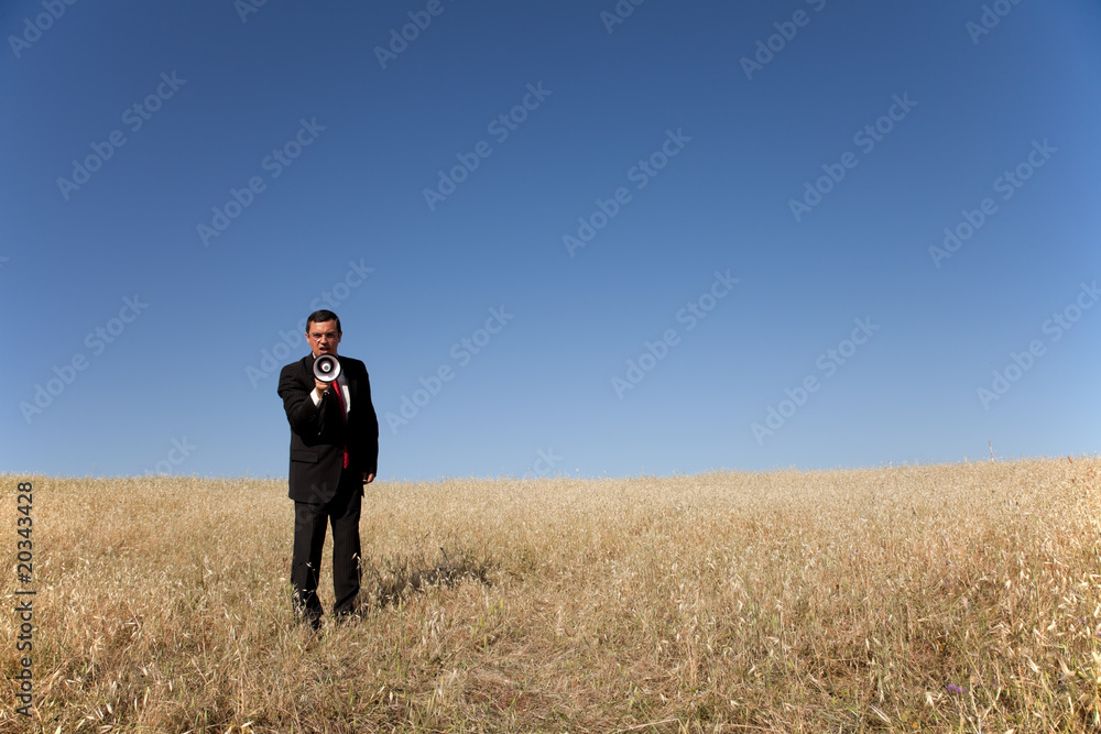 Businessman shouting at the megaphone to you Businessman shouting at the megaphone to you