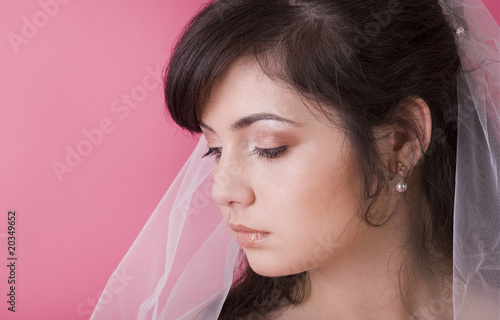 studio portrait of a happy bride with closed eyes