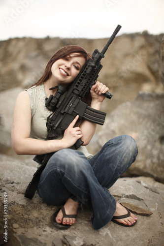 Sexy young woman with assault rifle