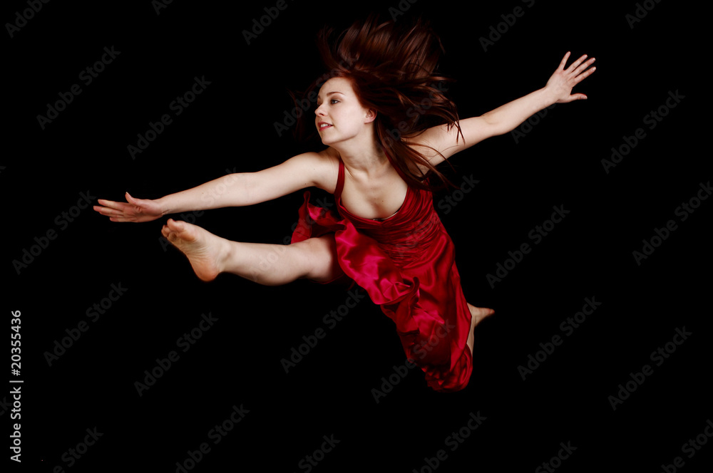 Woman in red dress jumping
