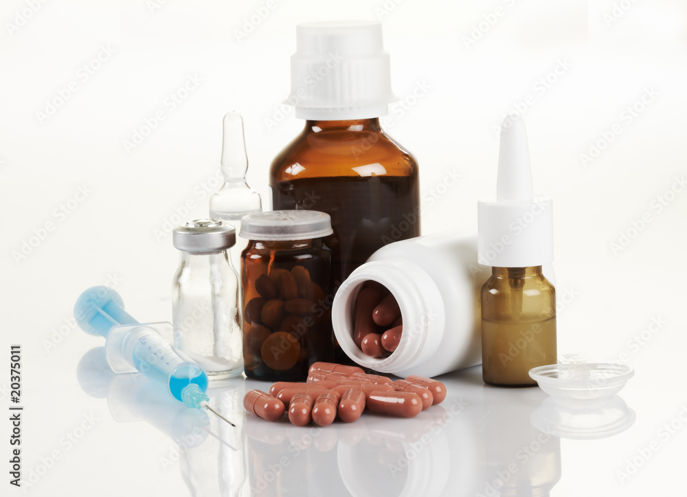 a set of medication boxes and various pills a set of medication boxes and various pills