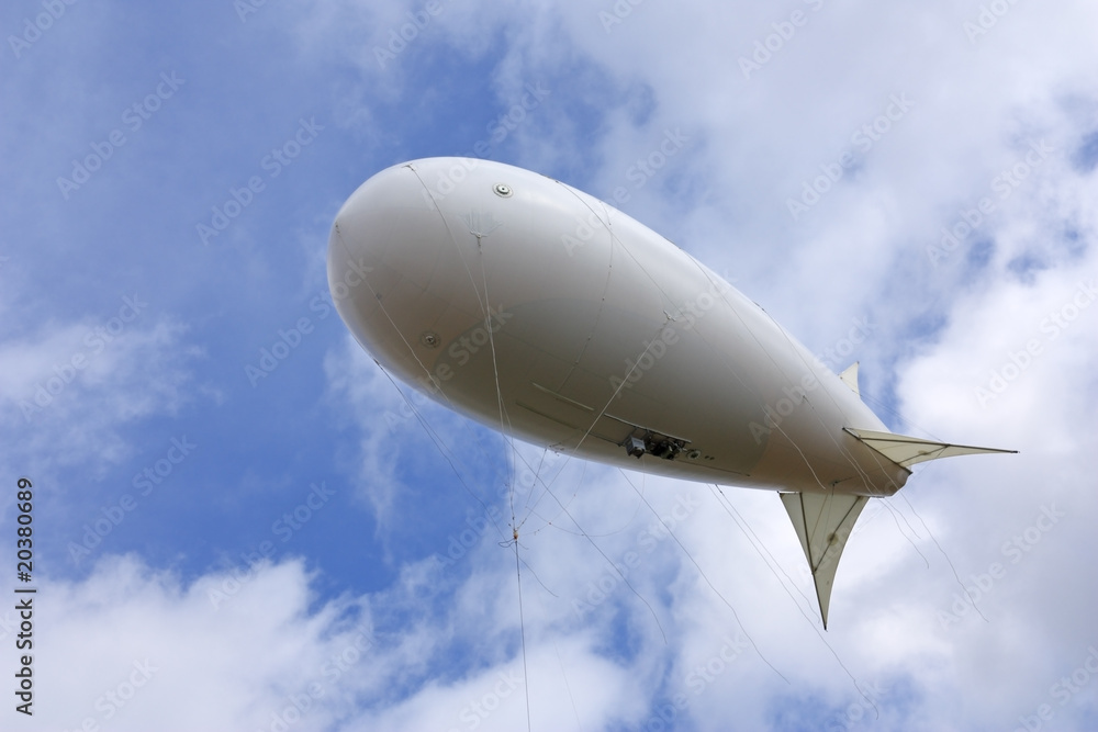 Obraz premium White balloon against the blue sky and clouds