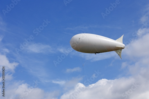 White balloon against the blue sky and clouds