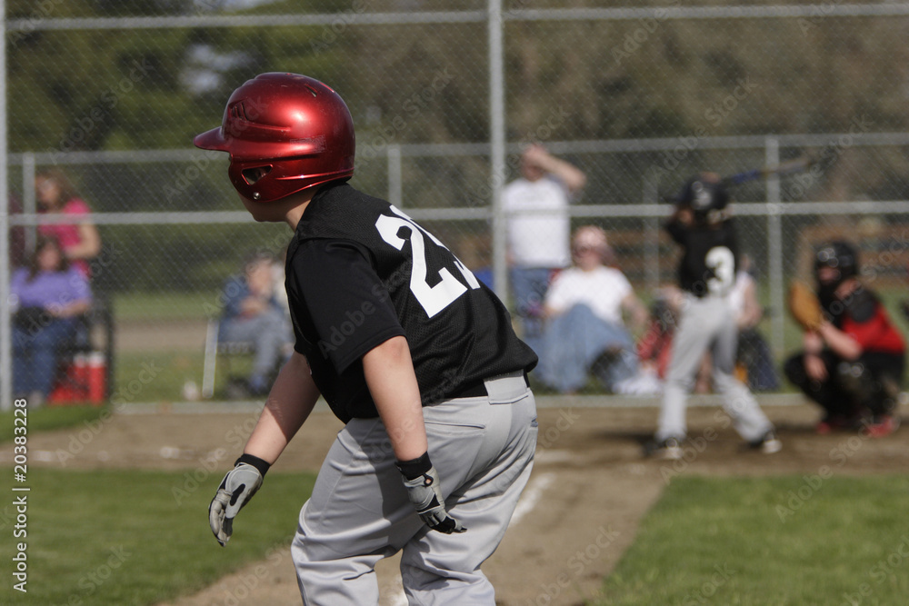 player leading off at third base while a teammate is up to bat