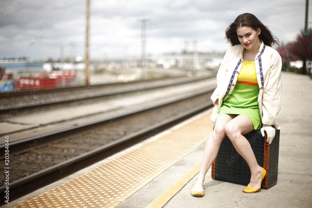 Young fashionable woman at train station