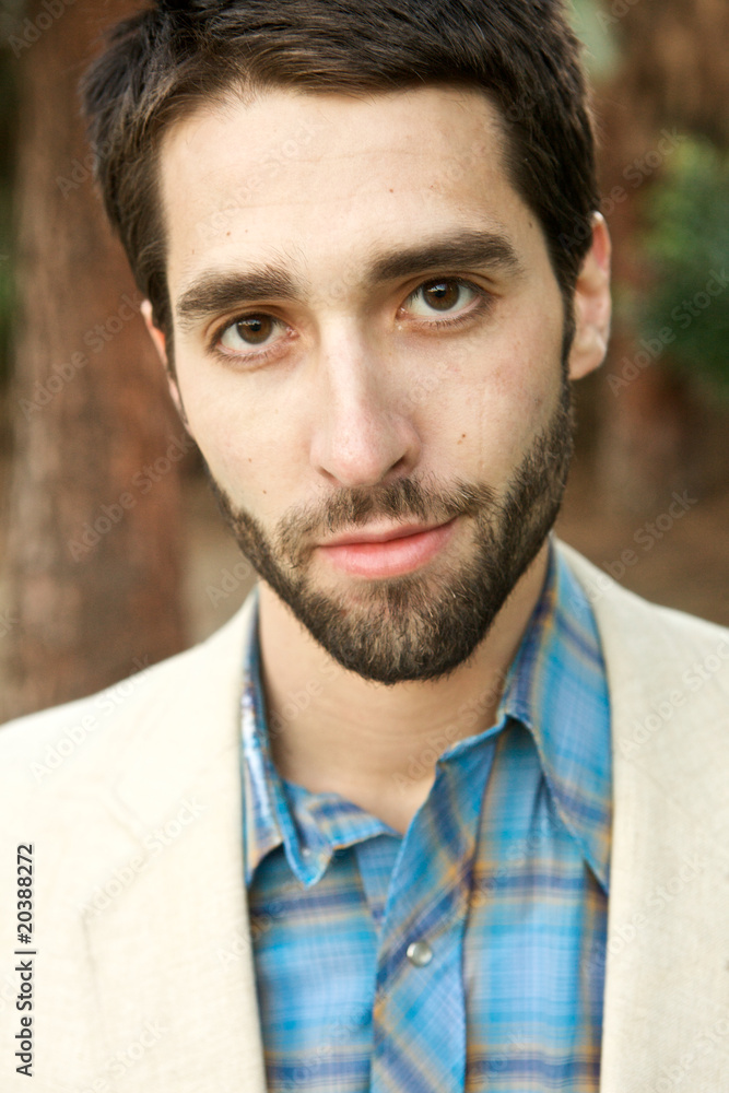 Fototapeta premium Attractive Young Man looking sternly at camera