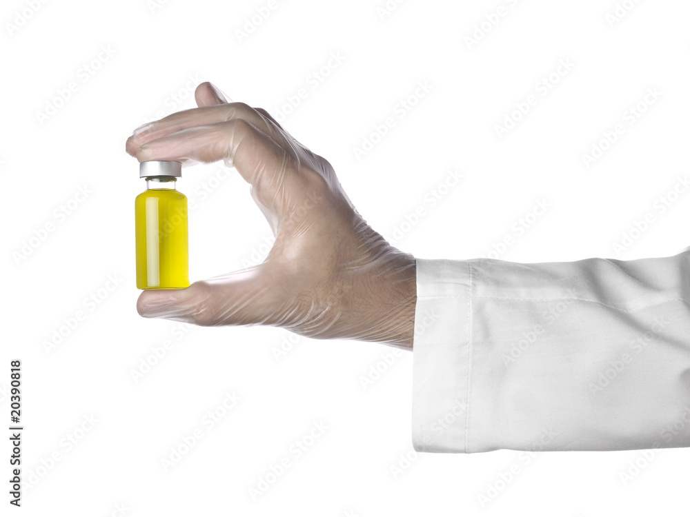 Fototapeta premium Yellow vial on a hand