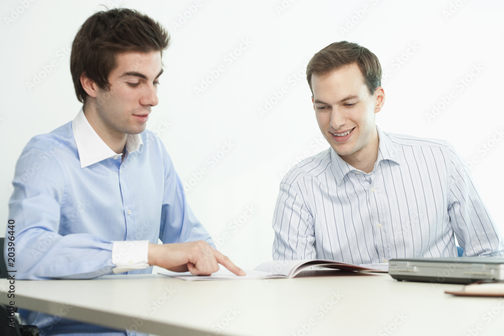 Handsome Young Businessmen Smiling and Reading Handsome Young Businessmen Smiling and Reading