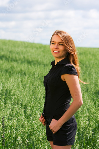 Happy young woman in a field.