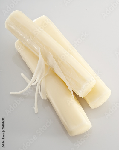 Three pieces of mozzarella string cheese isolated on white