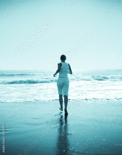 young woman jogging on the beach