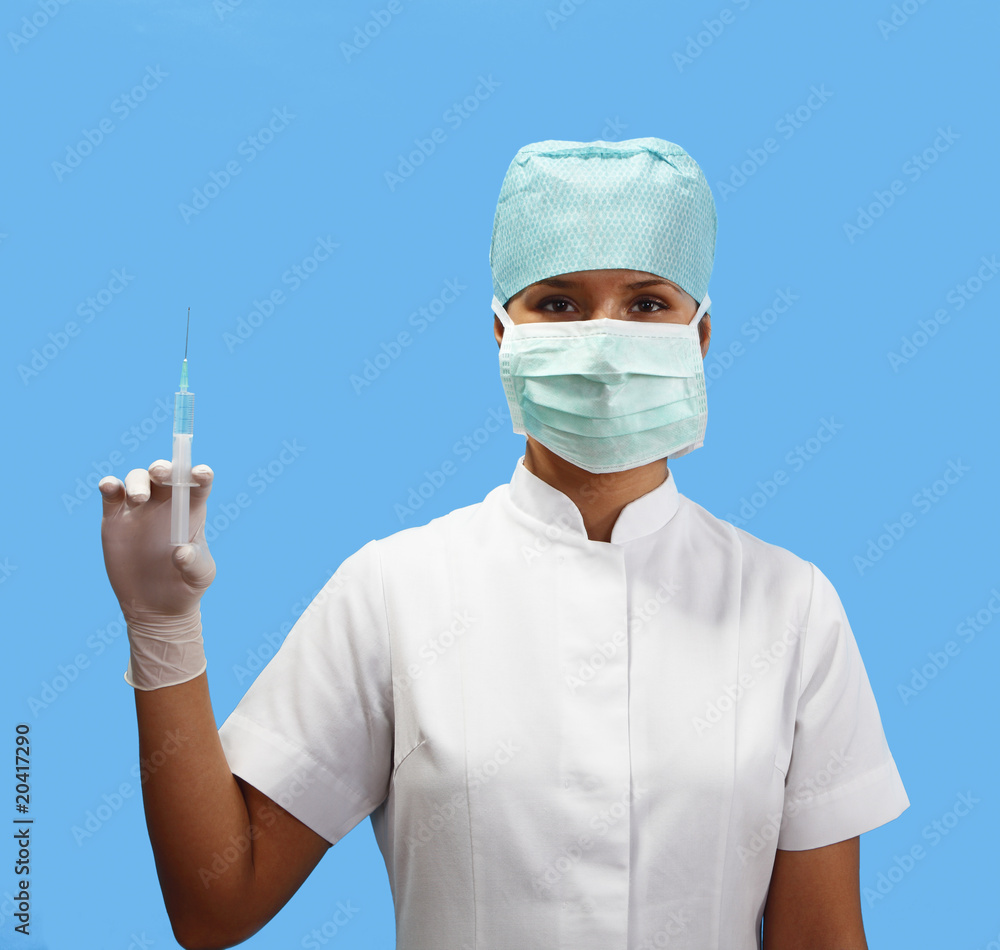 Female nurse holding a syringe Female nurse holding a syringe
