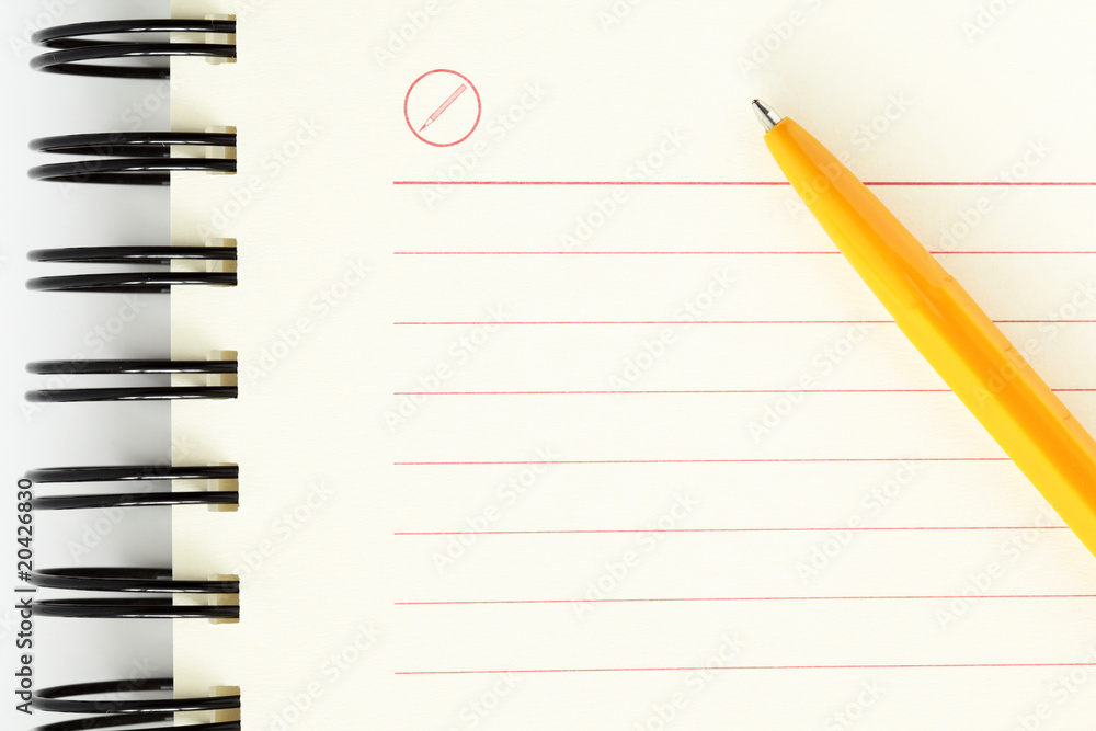 Clean sheet of notebook with orange pen Clean sheet of notebook with orange pen