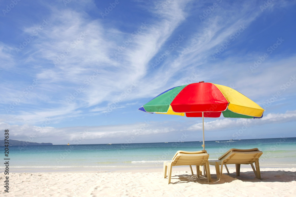 chairs and colorful umbrella on sand beach