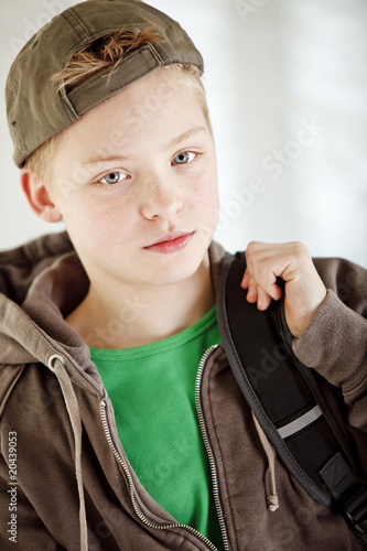 Boy carrying backpack on his way to school photo