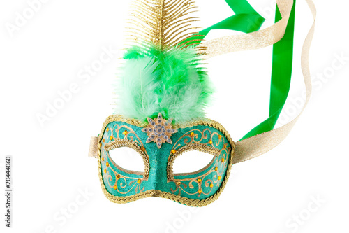 green and gold feathered carnival mask isolated on white