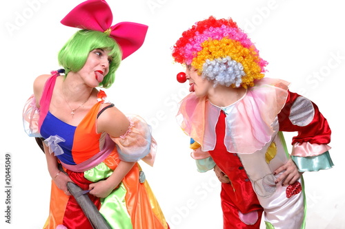 A portrait of two clown-girls in bright costumes