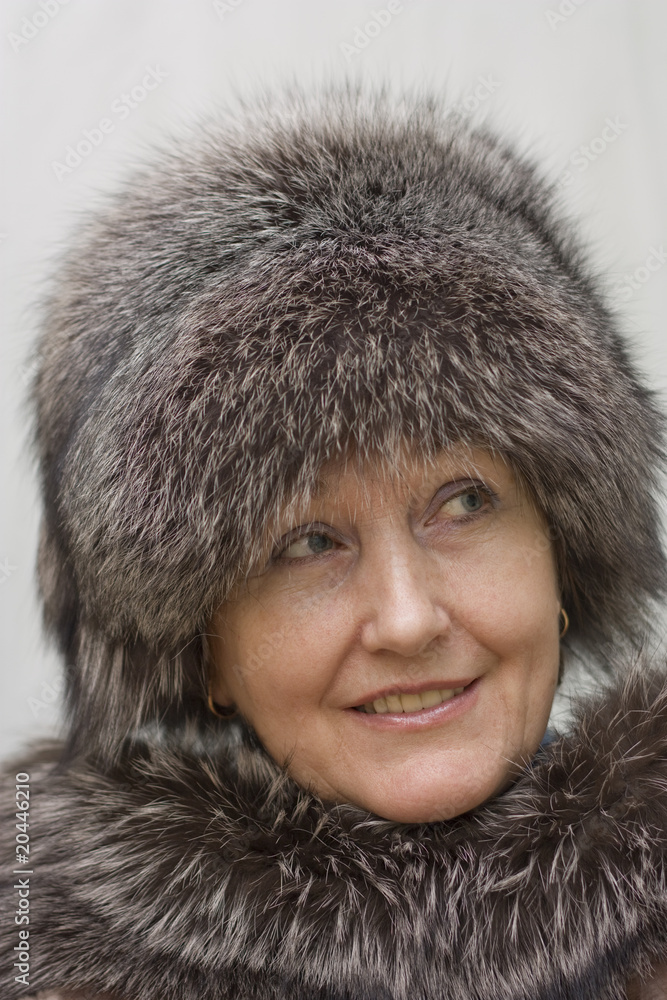 Portrait of a beautiful woman in a fur hat. Portrait of a beautiful woman in a fur hat.