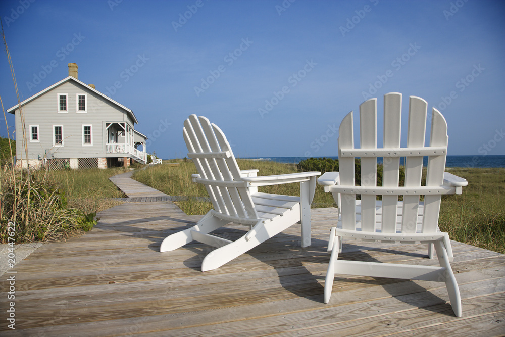 Chairs on Deck Facing Ocean - obrazy, fototapety, plakaty 