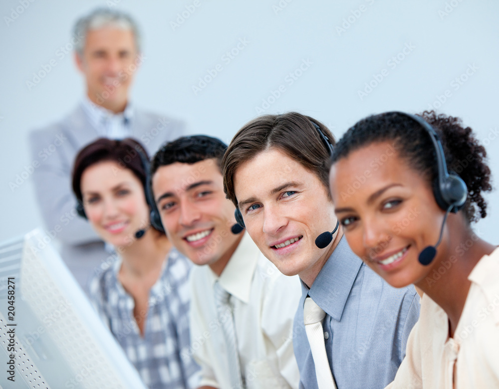 Cheerful business team working in a call center Cheerful business team working in a call center