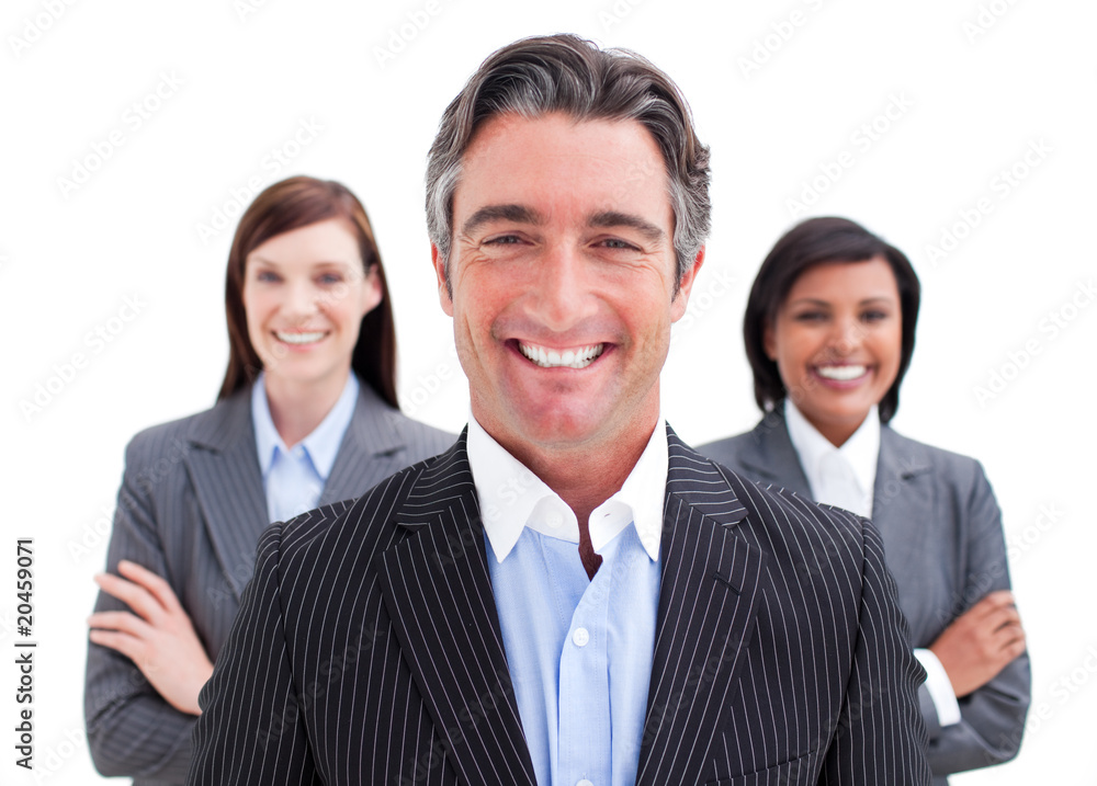Self-assured businessman posing in front of his team Self-assured businessman posing in front of his team
