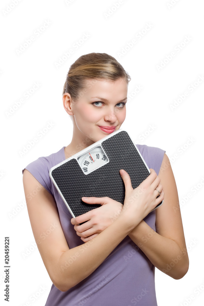 smiling young woman holding a weight scale