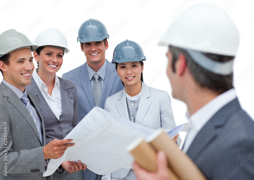 A group of architects studying blueprints A group of architects studying blueprints