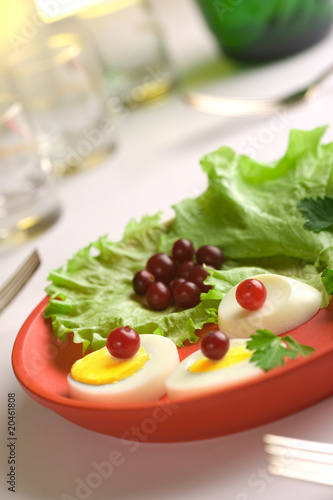 Served egg salad on a red round dish